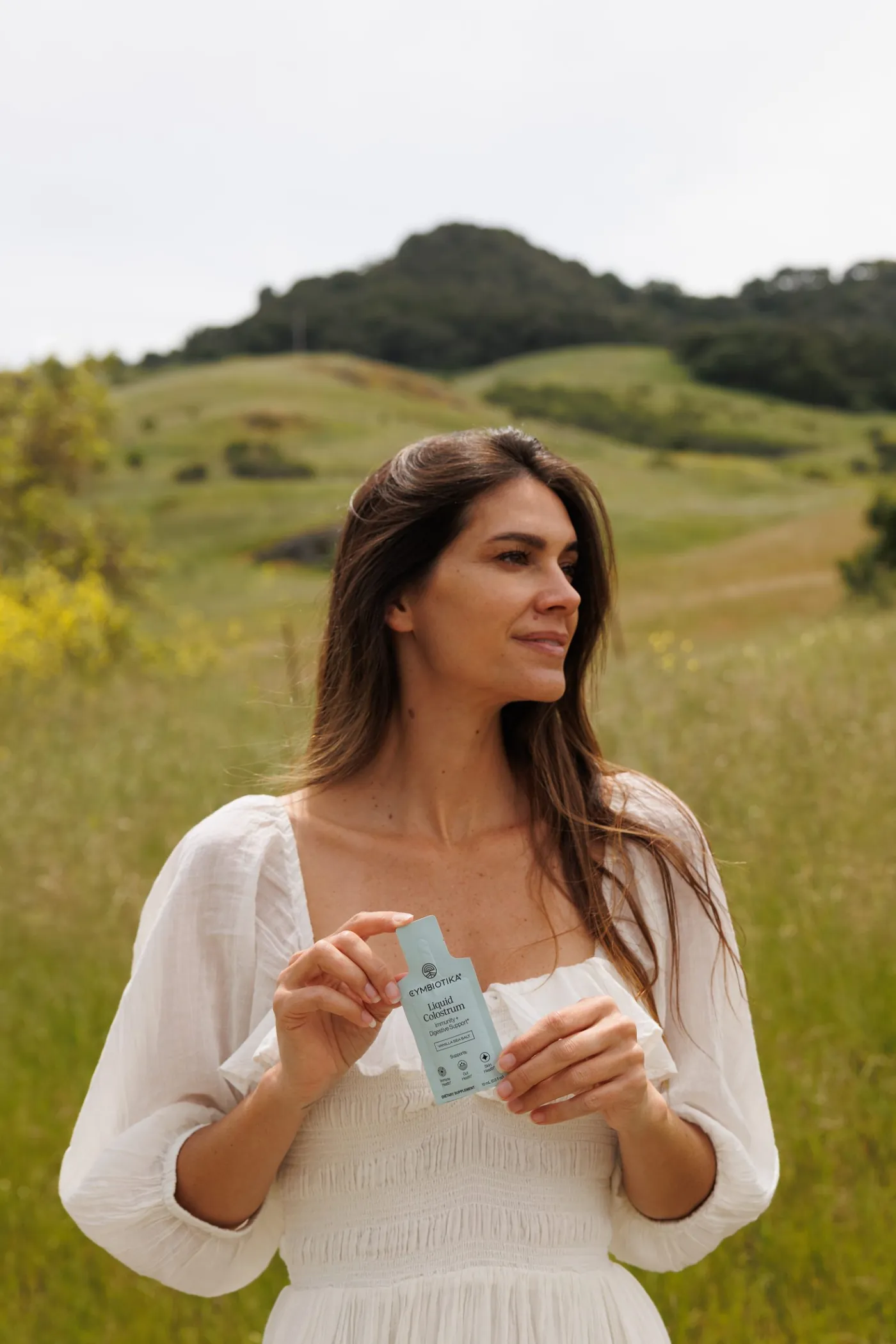 Woman in the hills holding Colostrum