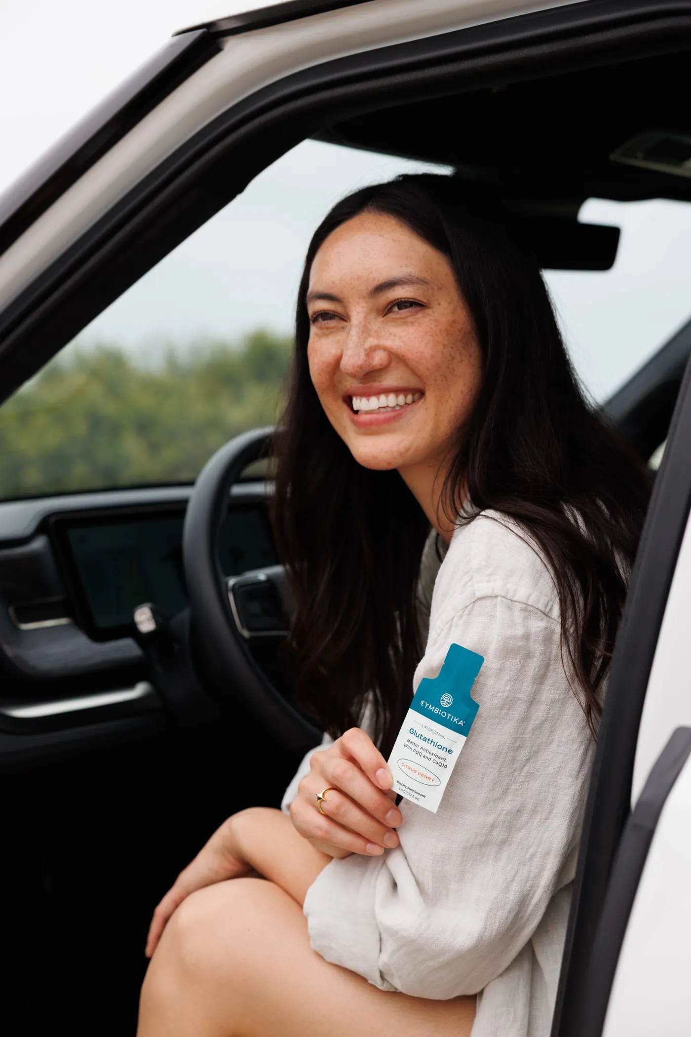 Woman in the Rivian holding Glutathione